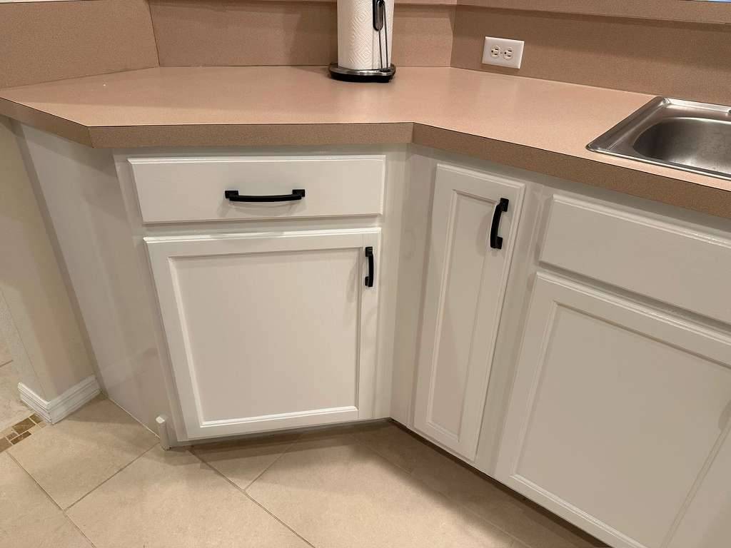 Close-up of clean white cabinet doors and countertop
