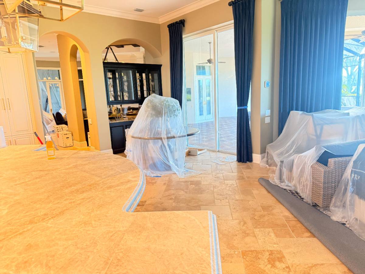 Interior living space with furniture covered in plastic during work