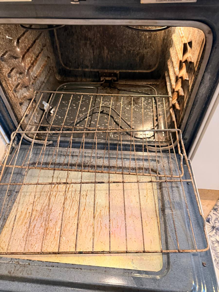 Heavily soiled oven interior before cleaning