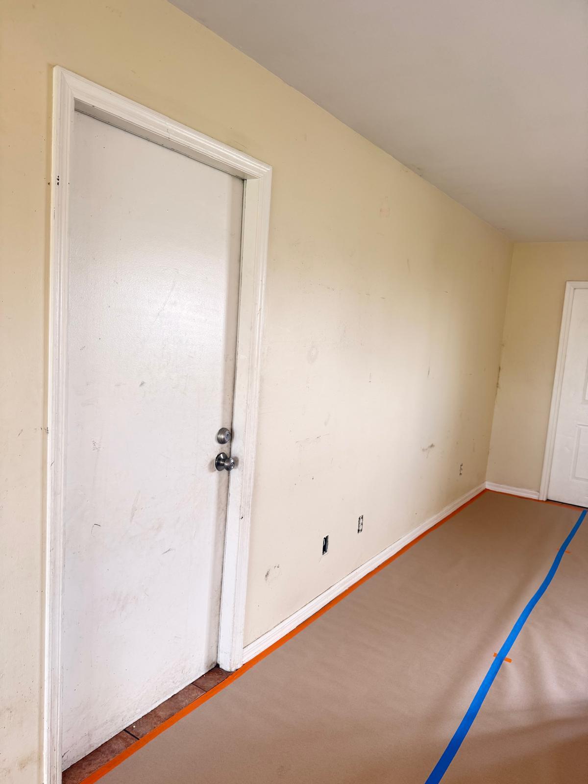 Scuffed yellow interior walls before painting